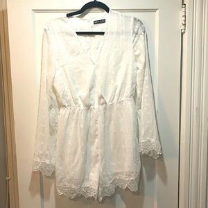 Adorable white romper with shimmer piping. New!